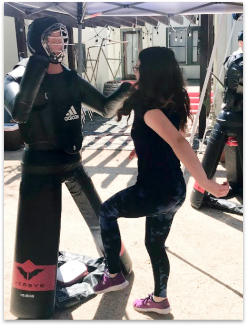 Girl kicking dummy
